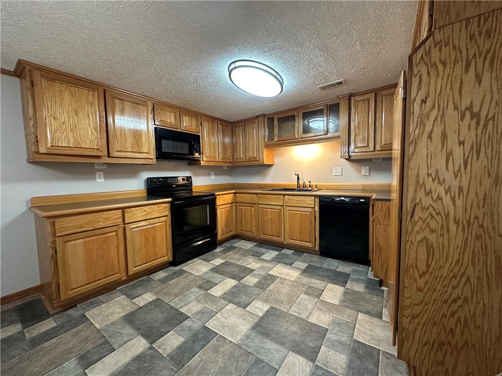 710 Spiva Road Temple, GA 30179 - Photo 14 of 31 a kitchen with stainless steel appliances granite countertop a stove sink and cabinets