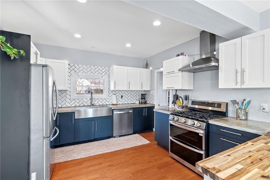 449 Elwyn Avenue Springdale, PA 15144 - Photo 20 of 46 a kitchen with stainless steel appliances granite countertop a stove and a refrigerator