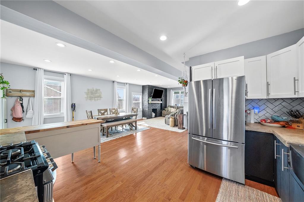 449 Elwyn Avenue Springdale, PA 15144 - Photo 23 of 46 a kitchen with stainless steel appliances a refrigerator a stove a sink cabinets and wooden floor