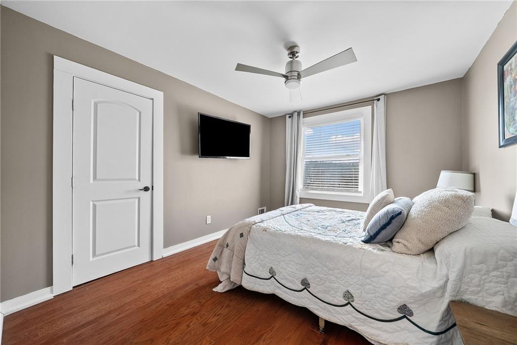 449 Elwyn Avenue Springdale, PA 15144 - Photo 25 of 46 a bedroom with a large bed and a flat tv screen