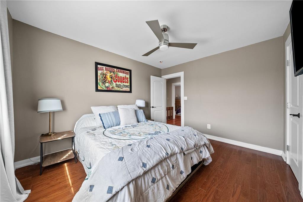449 Elwyn Avenue Springdale, PA 15144 - Photo 26 of 46 a bedroom with a bed and a painting on the wall