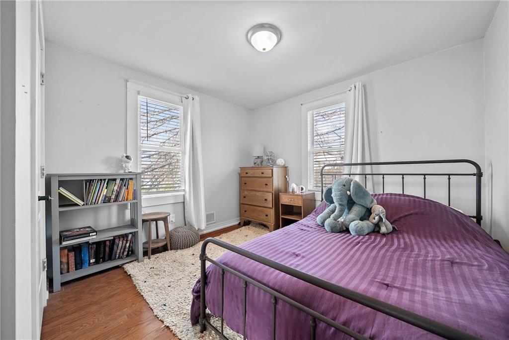 449 Elwyn Avenue Springdale, PA 15144 - Photo 34 of 46 a bedroom with a bed and a book shelf