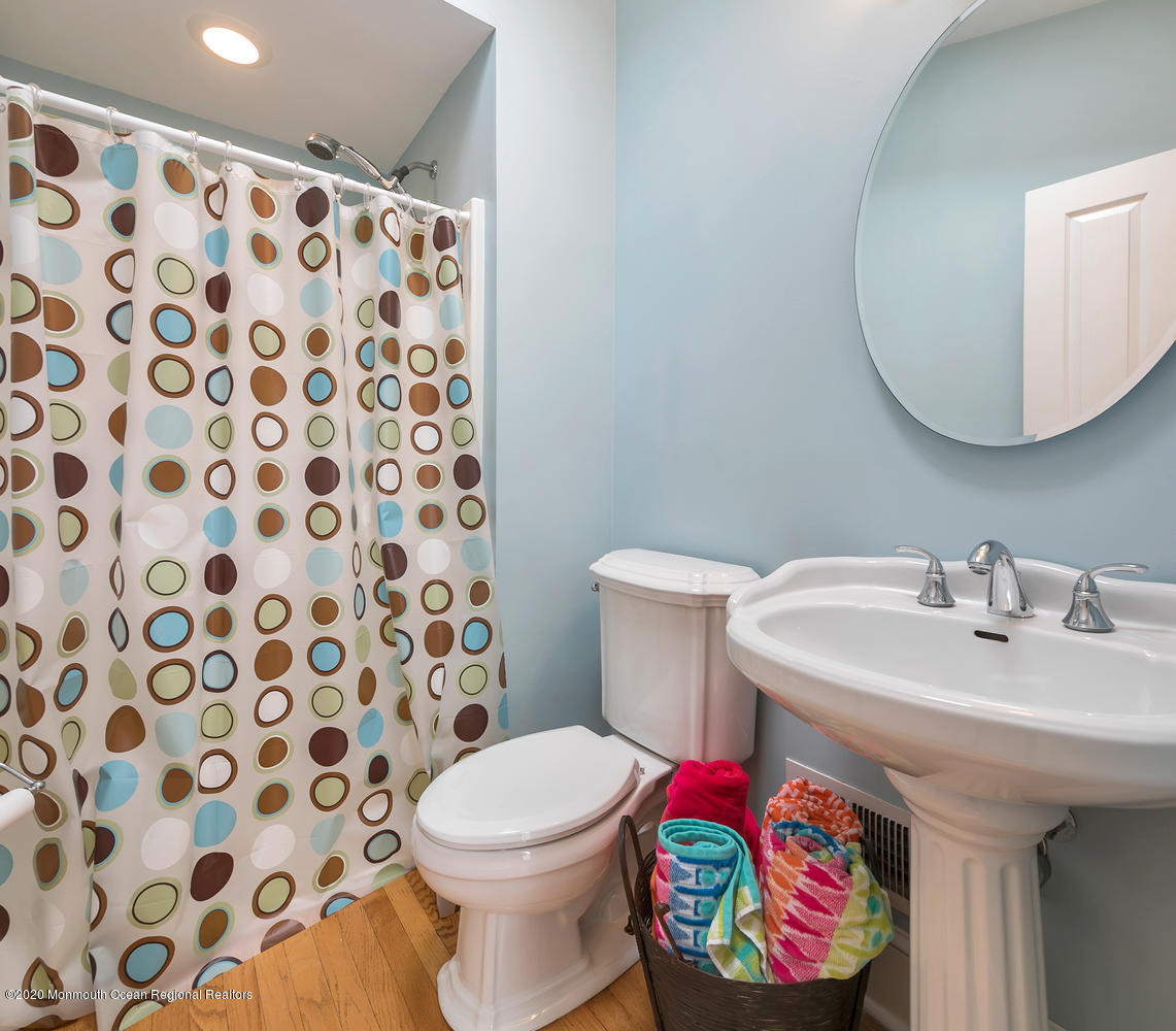 408 Tuttle Avenue Spring Lake, NJ 07762 - Photo 16 of 36 a bathroom with a sink and a mirror