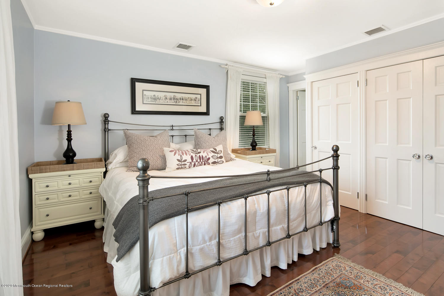 408 Tuttle Avenue Spring Lake, NJ 07762 - Photo 20 of 36 a bedroom with a bed and a chandelier