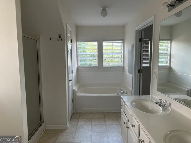 a bathroom with a tub sink and a mirror