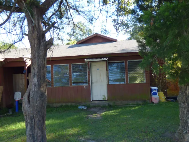 a front view of house with a garden