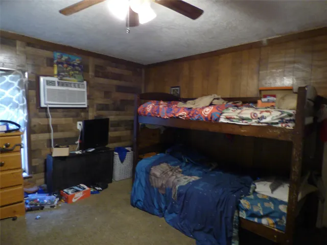 a bedroom with a bed and a mirror