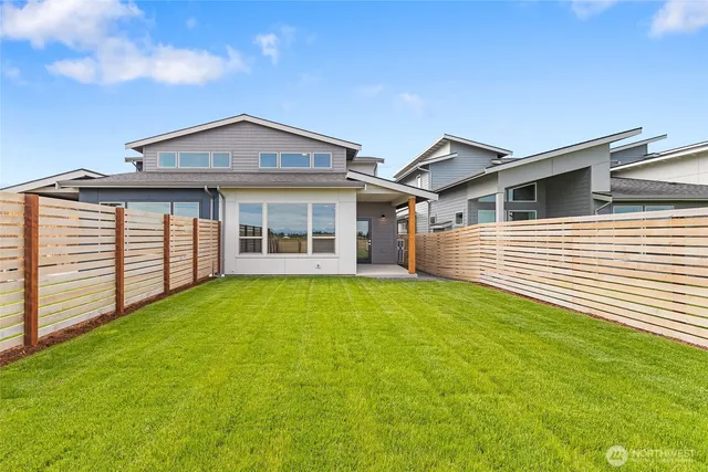 a view of a house with a backyard