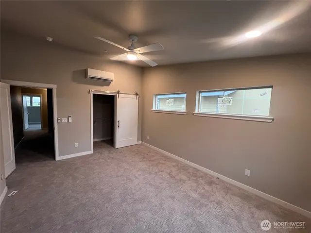 an empty room with windows and closet