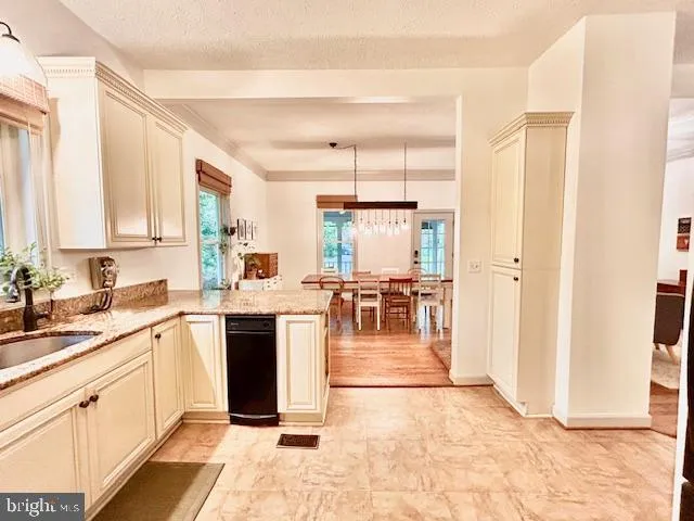 a kitchen with a sink cabinets and window
