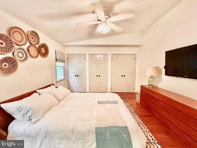 a bedroom with a large bed and a flat screen tv