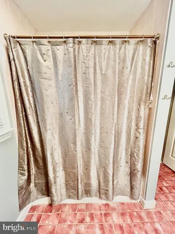 a view of a closet with wooden floor