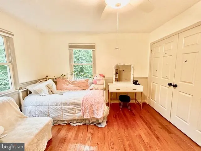 a bedroom with a bed and a wooden floor
