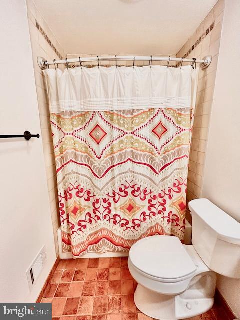 510 Washington Grove Lane Washington Grove, MD 20880 - Photo 22 of 45 a bathroom with a toilet and a shower curtain