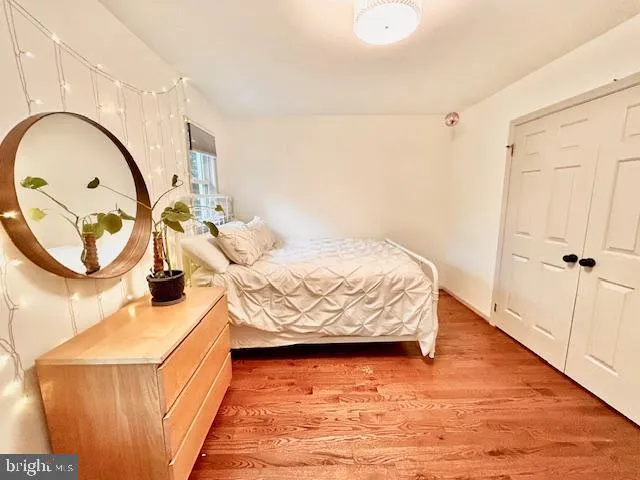 a bedroom with a bed and a mirror