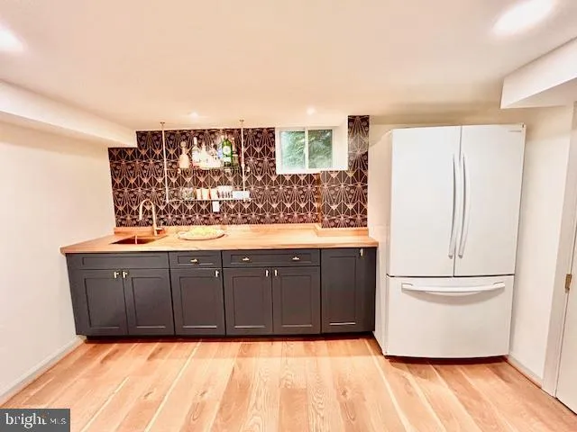 a kitchen with stainless steel appliances granite countertop a refrigerator and a stove