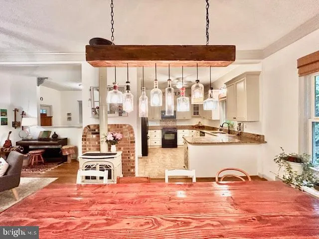 a room with stainless steel appliances kitchen island granite countertop a sink and cabinets