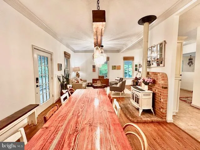 a very nice looking living room with a large window and wooden floor