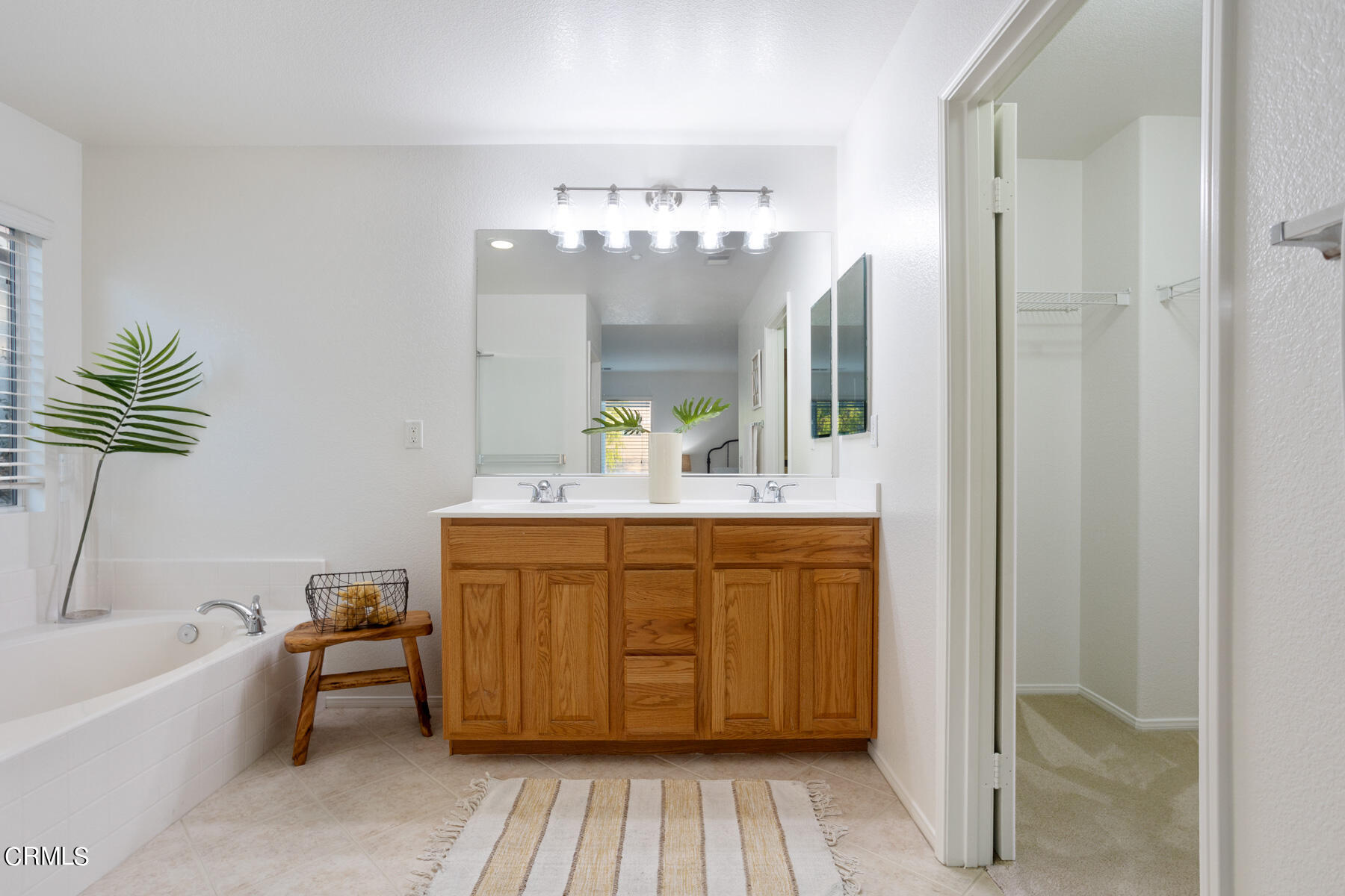 12435 Serrano Way Sylmar, CA 91342 - Photo 12 of 19 a bathroom with a tub sink and mirror