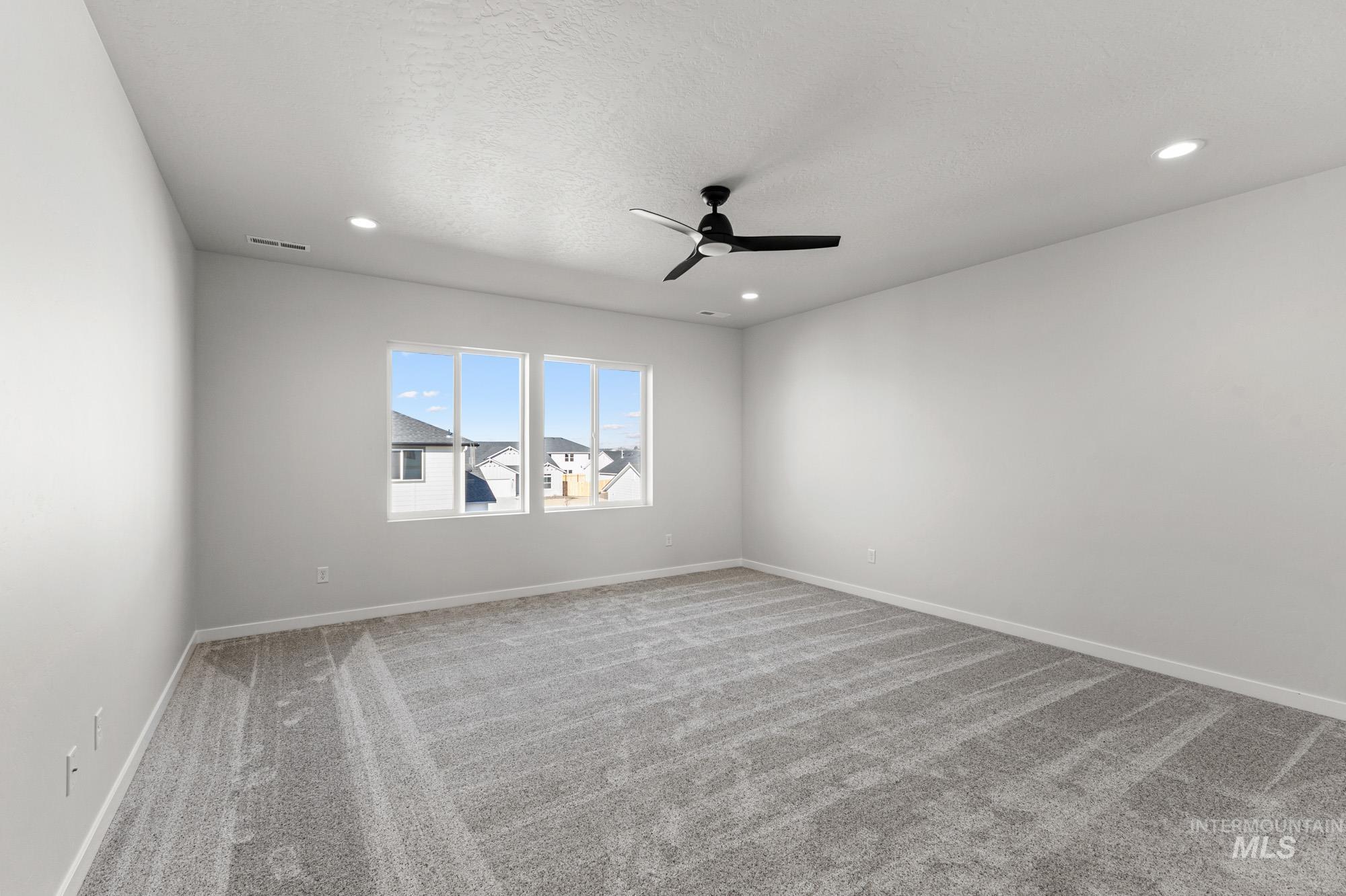 13708 Judson Street Caldwell, ID 83607 - Photo 24 of 29 Empty room featuring carpet, a ceiling fan, recessed lighting, and a textured ceiling