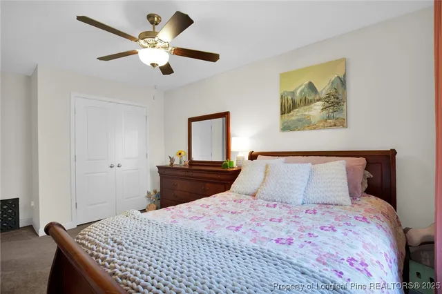 a bedroom with a large bed and a chandelier