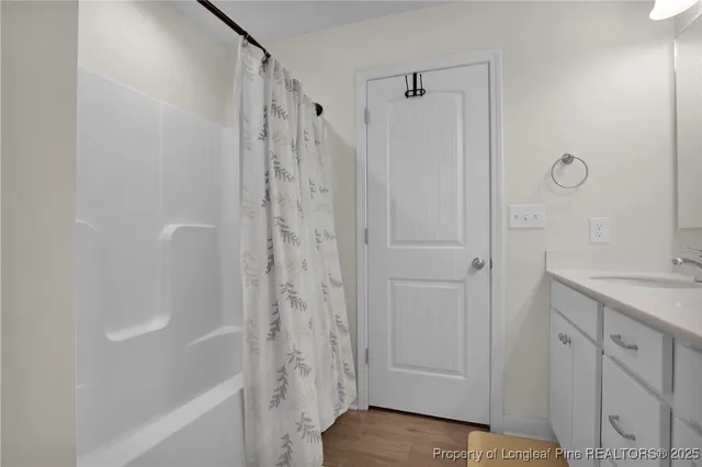 a bathroom with a shower and a sink