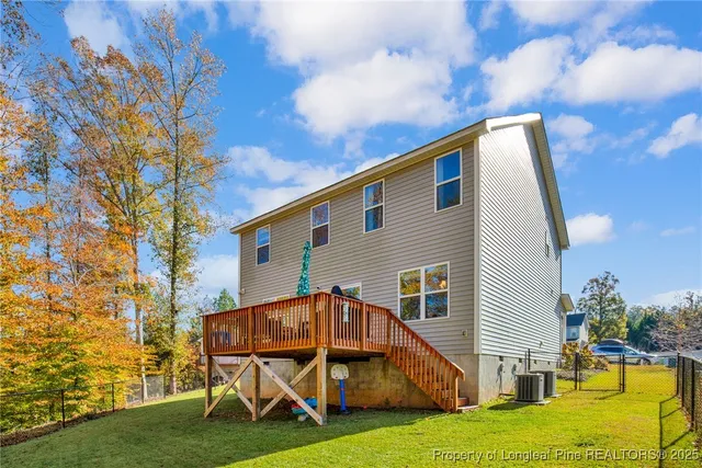 a view of house with backyard