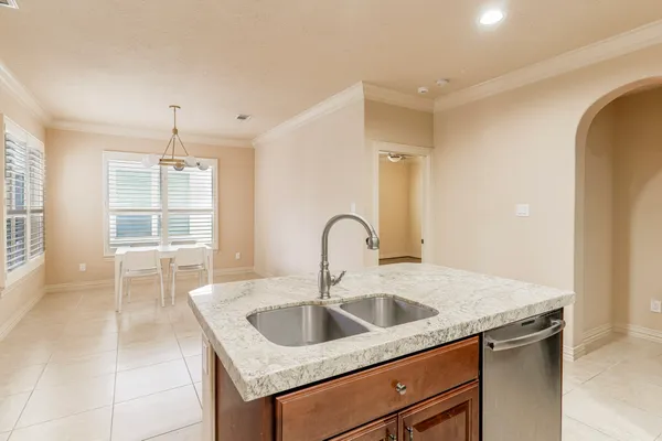 a kitchen with a sink cabinets and window