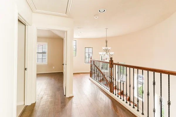 a view of a hallway view with wooden floor and staircase