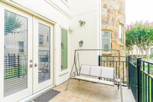 a view of porch with a bench and floor to ceiling window