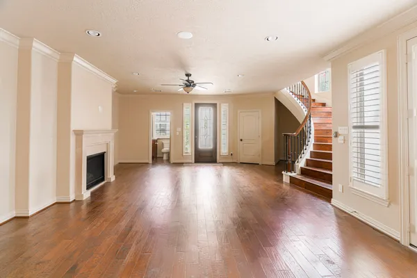a view of a livingroom with wooden floor and fireplace