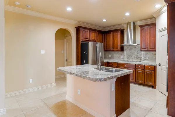 a kitchen with stainless steel appliances granite countertop a sink a counter space and cabinets