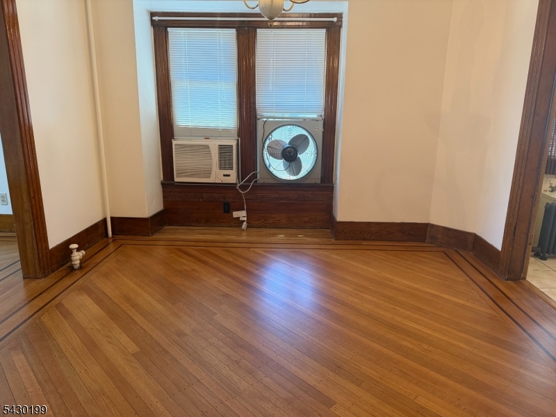 72 Baldwin Place, Unit 2 Bloomfield, NJ 07003 - Photo 6 of 24 an empty room with wooden floor and windows