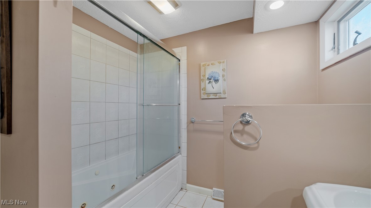 546 Twitchell Road Mansfield, OH 44903 - Photo 26 of 47 Bathroom with tile patterned floors and enclosed tub / shower combo