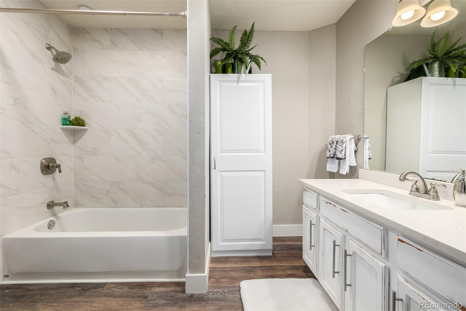 363 Neal Road Bailey, CO 80421 - Photo 13 of 39 a bathroom with a tub sink and mirror