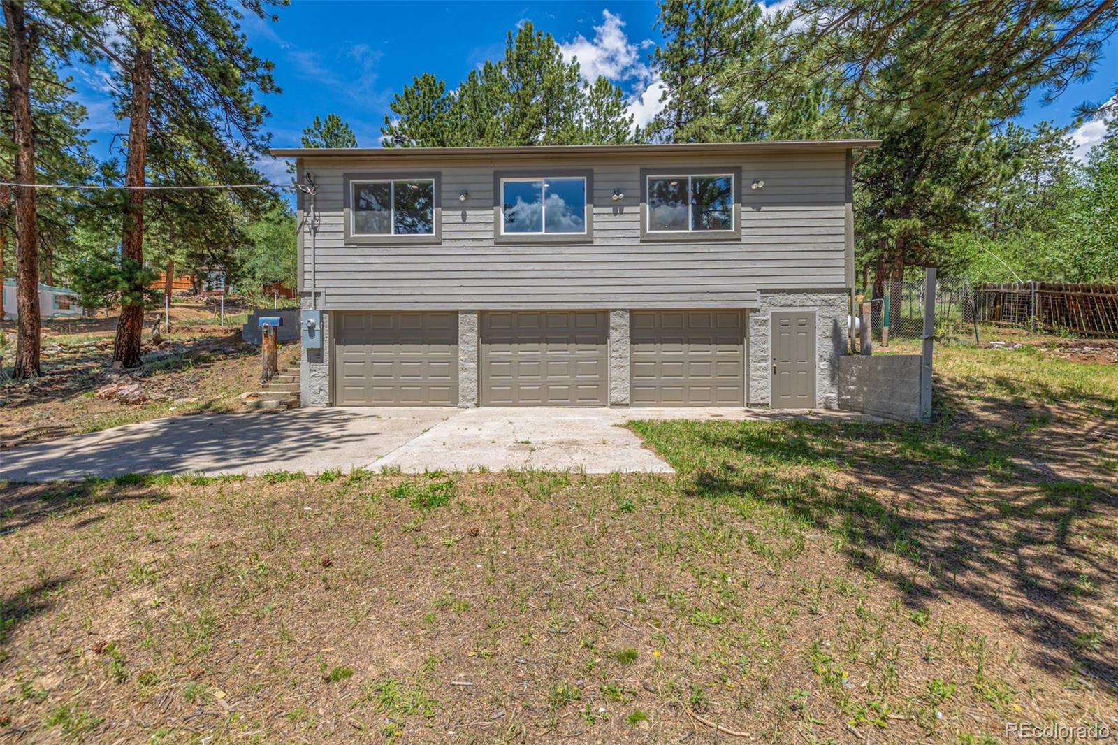 363 Neal Road Bailey, CO 80421 - Photo 22 of 39 a front view of a house with garden