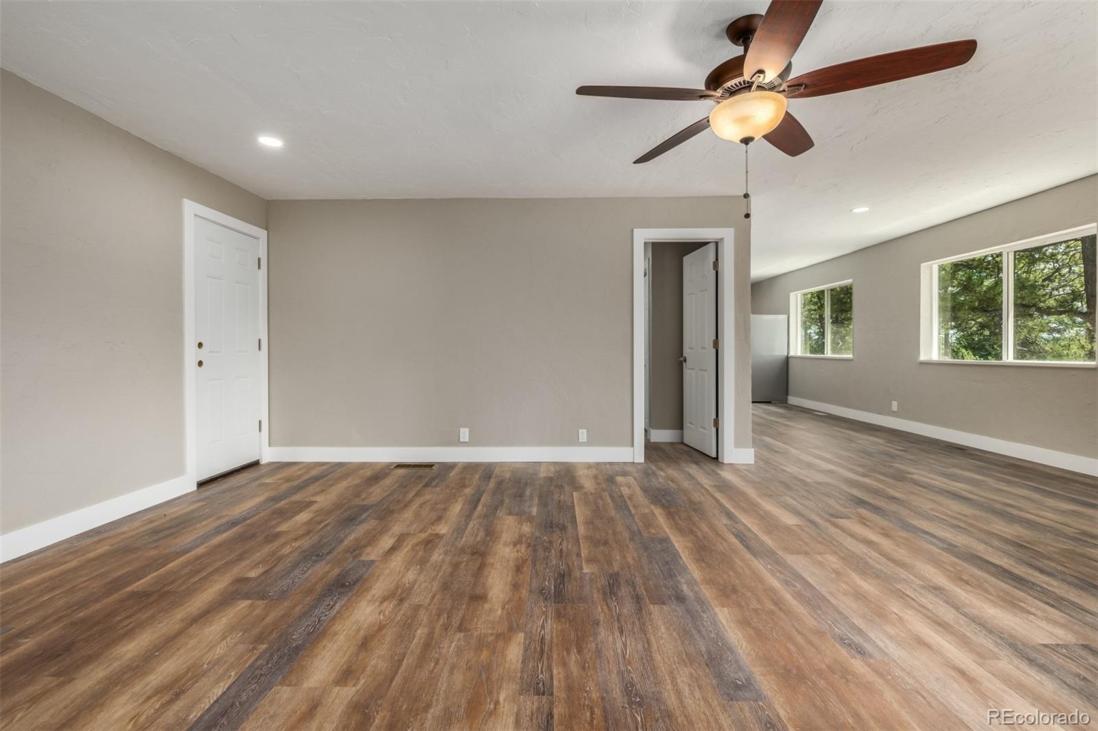 363 Neal Road Bailey, CO 80421 - Photo 25 of 39 a view of empty room with wooden floor and fan