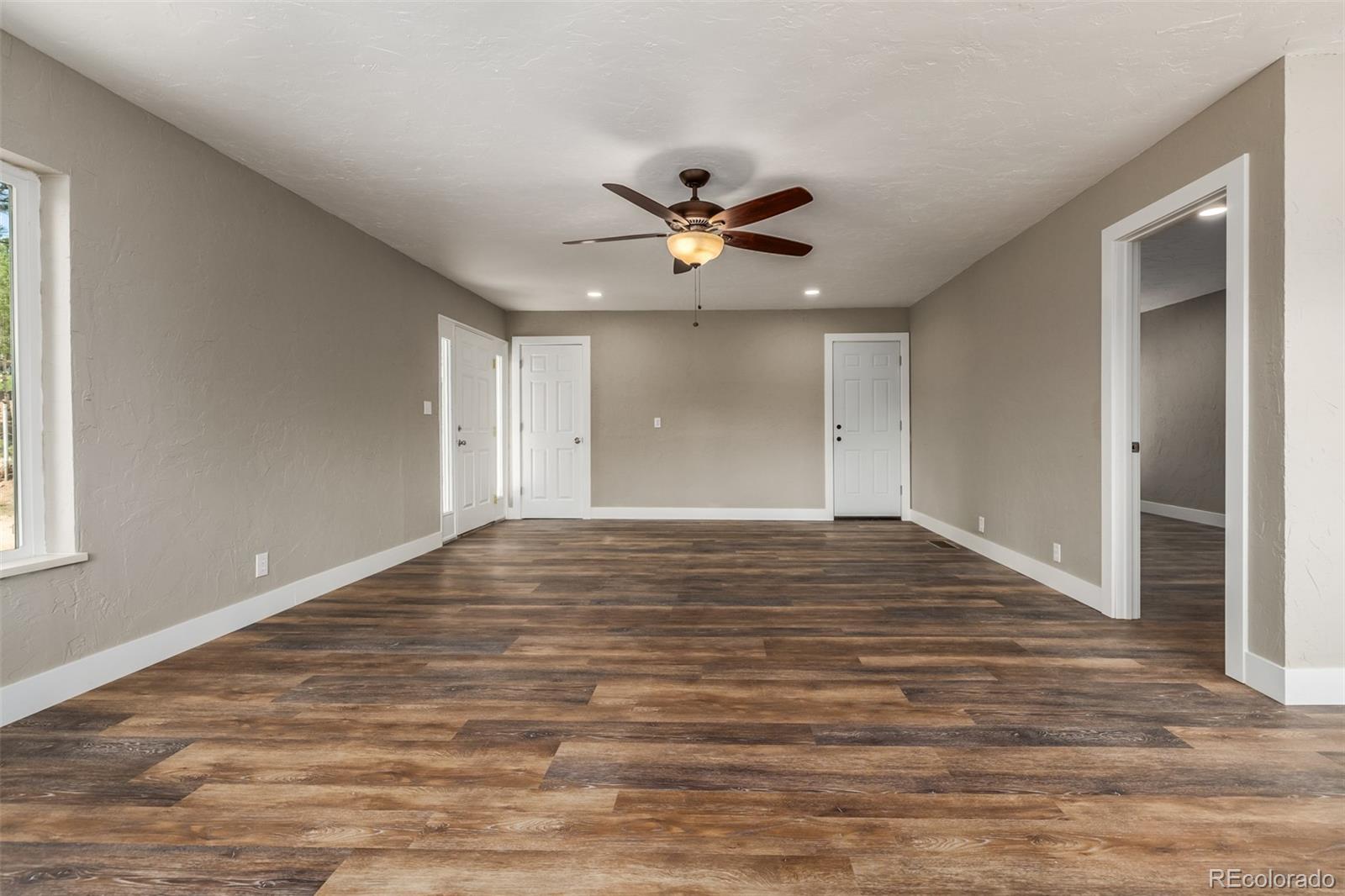 363 Neal Road Bailey, CO 80421 - Photo 26 of 39 a view of empty room with wooden floor and fan