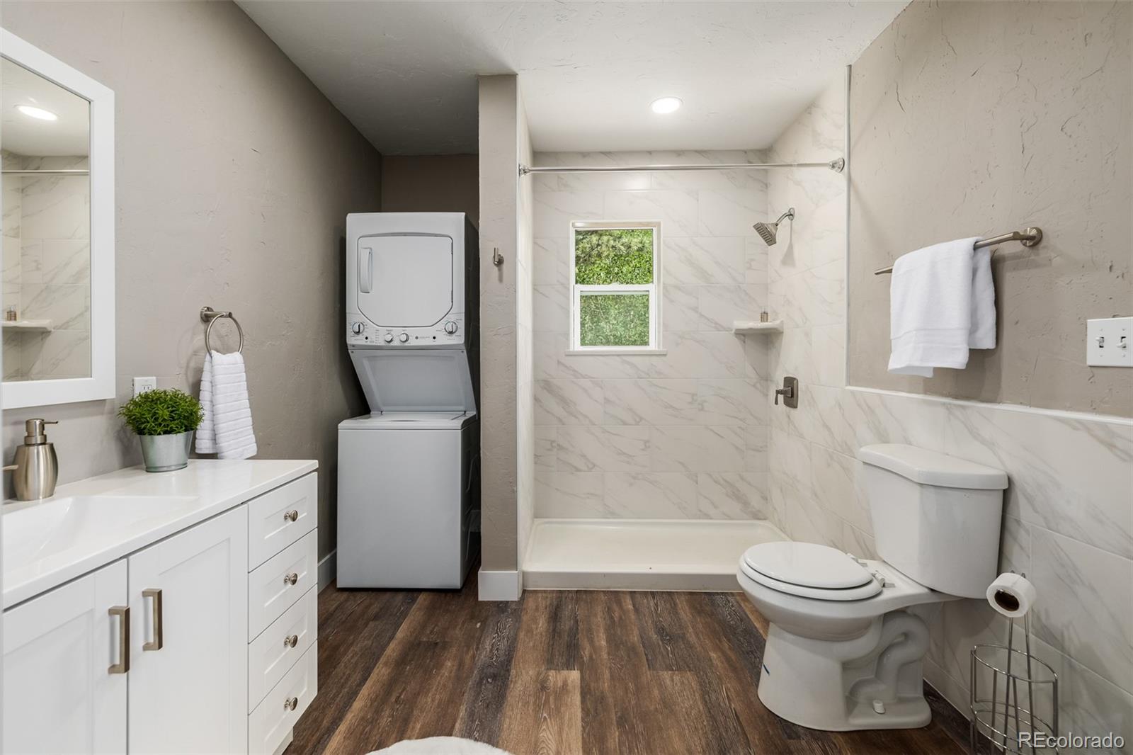 363 Neal Road Bailey, CO 80421 - Photo 29 of 39 a bathroom with a sink toilet and shower