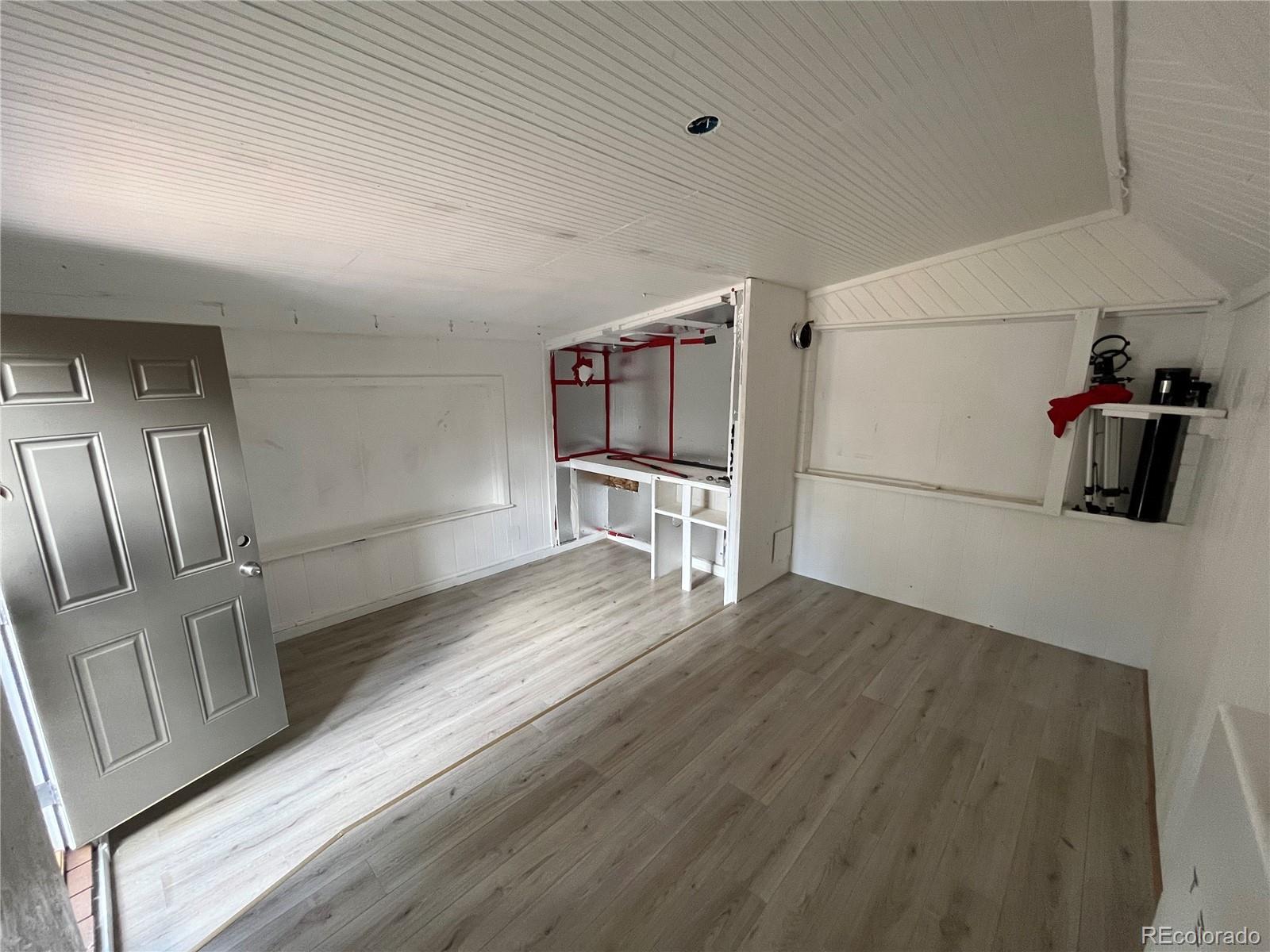 363 Neal Road Bailey, CO 80421 - Photo 34 of 39 a view of a kitchen with wooden floor and electronic appliances