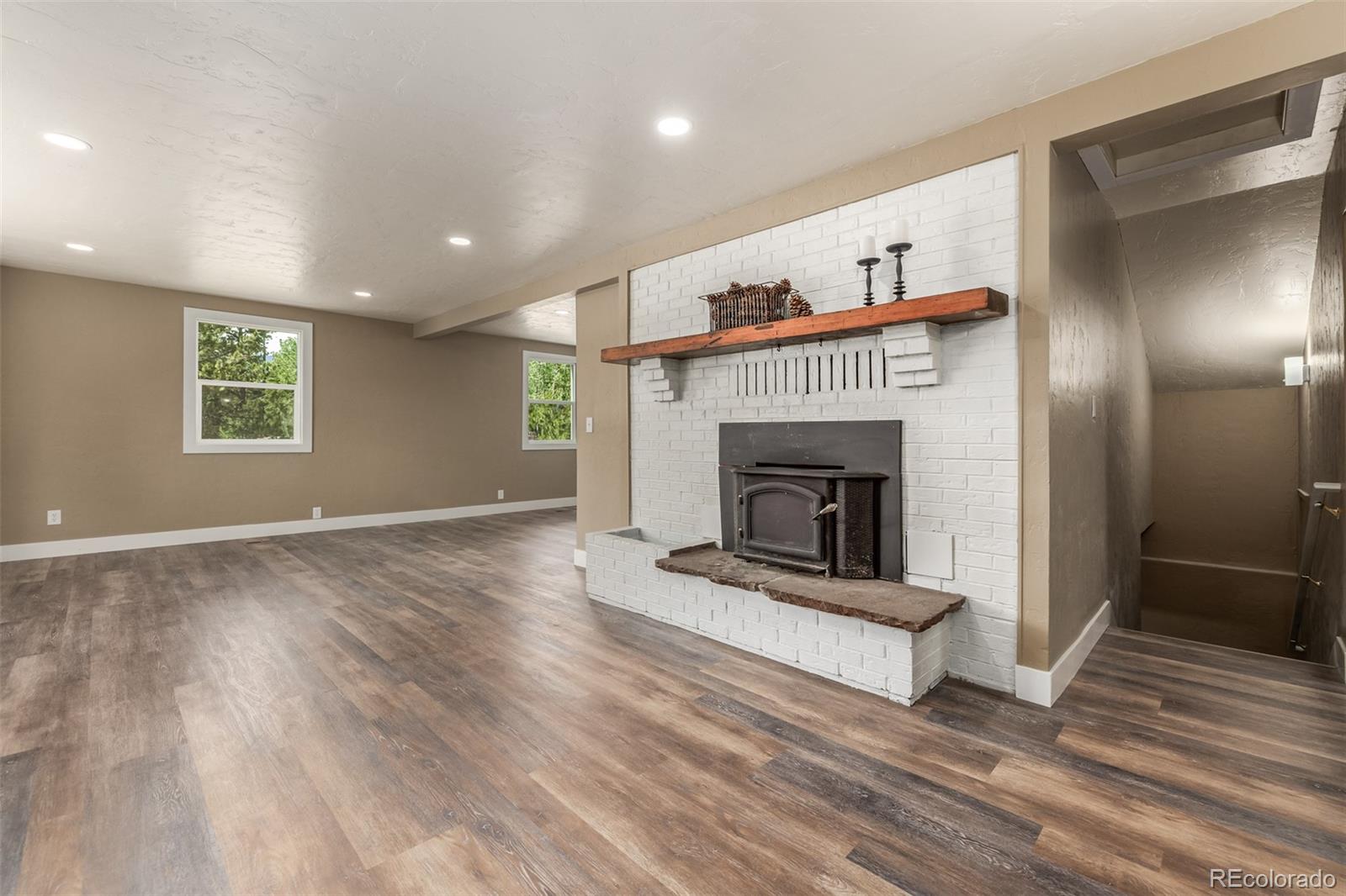 363 Neal Road Bailey, CO 80421 - Photo 6 of 39 a view of a livingroom with a fireplace and window