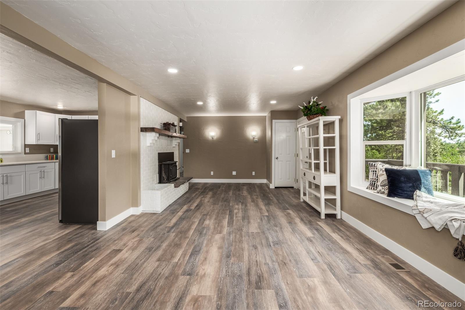 363 Neal Road Bailey, CO 80421 - Photo 7 of 39 a view of livingroom with furniture wooden floor and window
