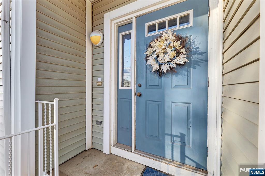 a vase of flowers sitting on a wooden door