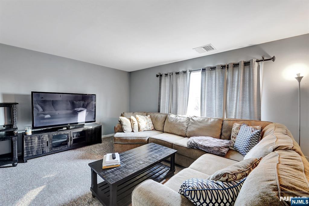 2 Grand Avenue, Unit 2 Hawthorne, NJ 07506 - Photo 3 of 8 a living room with furniture and a flat screen tv