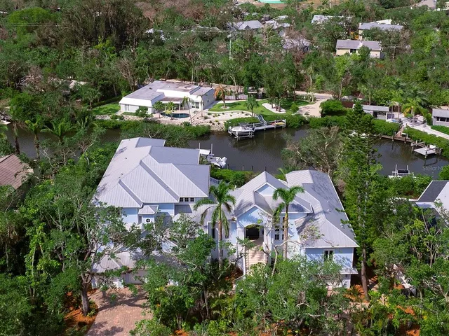 an aerial view of a house with a lake view