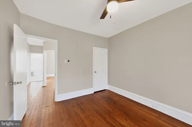 a view of a room with wooden floor