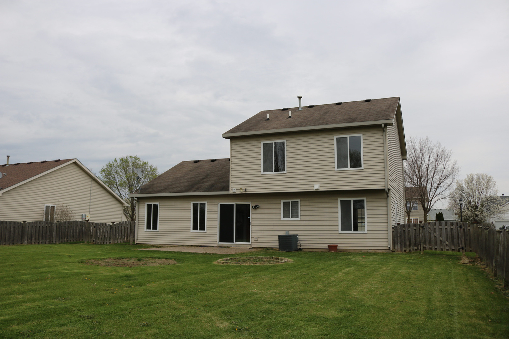 515 May Street Plano, IL 60545 - Photo 2 of 14 a view of a yard in front of a house with a large tree