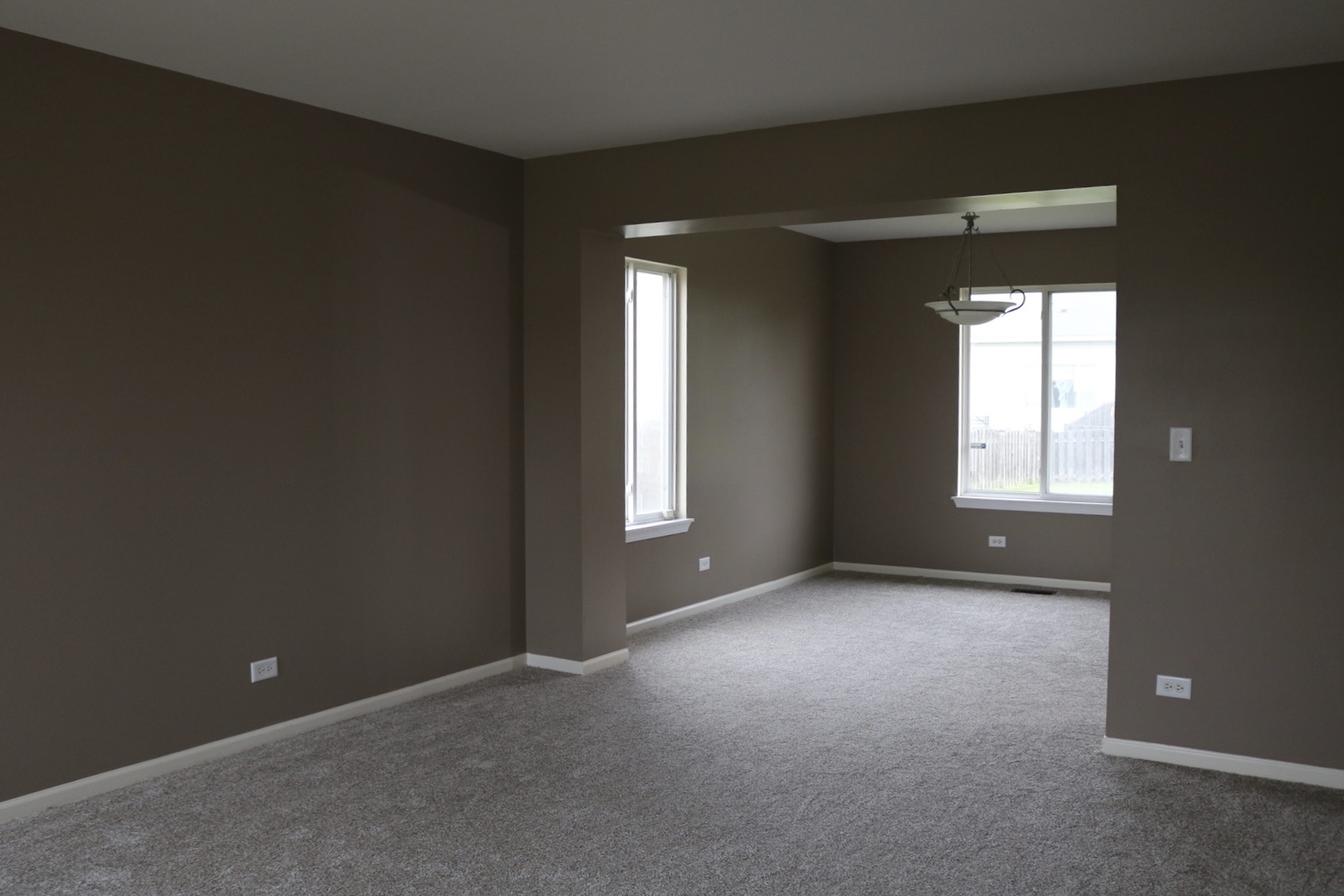 515 May Street Plano, IL 60545 - Photo 3 of 14 an empty room that has a window
