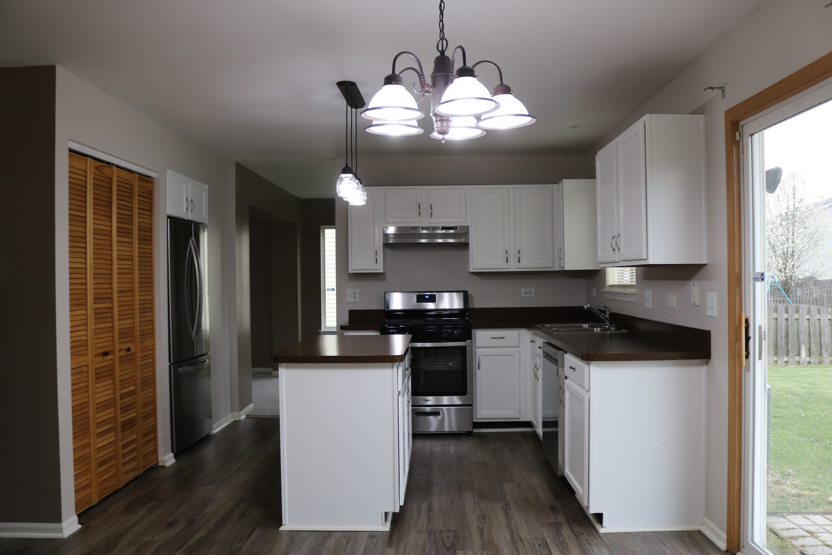 515 May Street Plano, IL 60545 - Photo 5 of 14 a kitchen with a sink and cabinets
