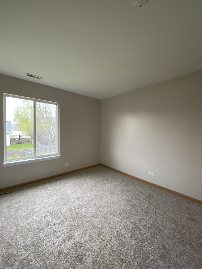 515 May Street Plano, IL 60545 - Photo 10 of 14 an empty room with a window